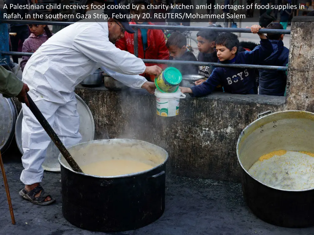 a palestinian child receives food cooked