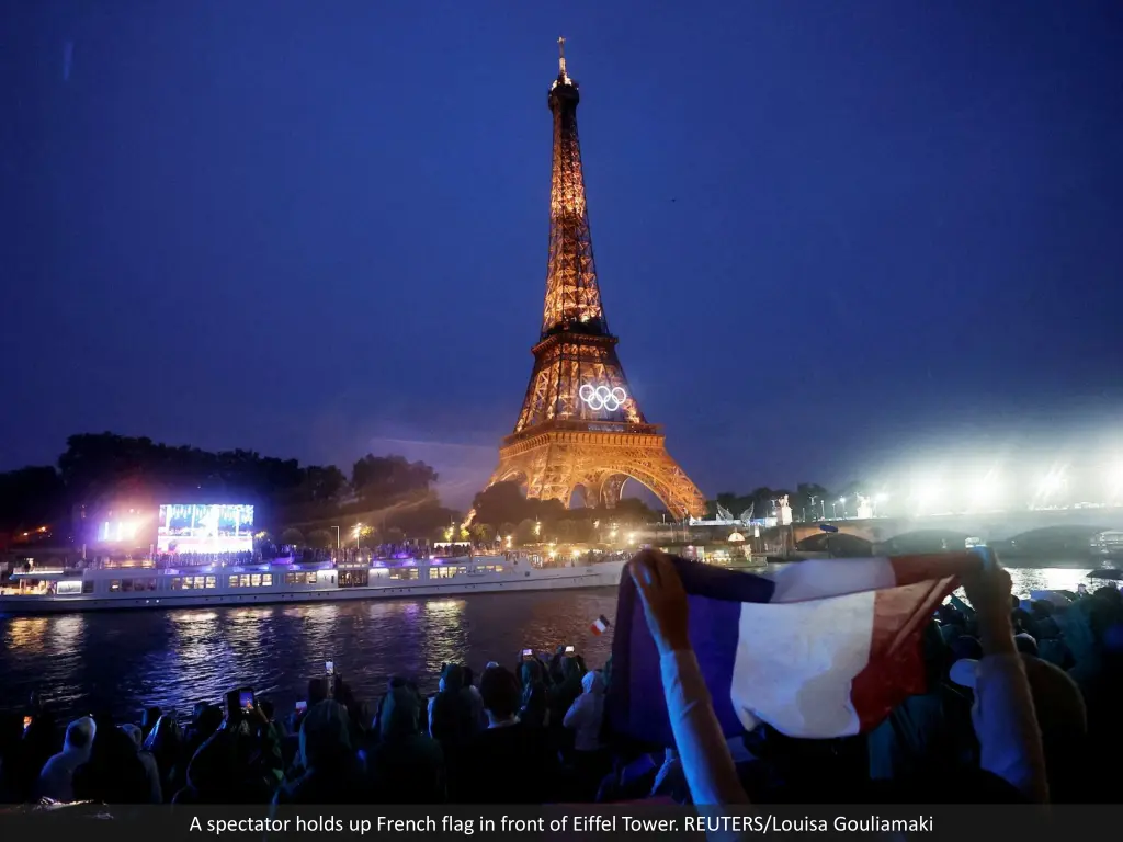 a spectator holds up french flag in front