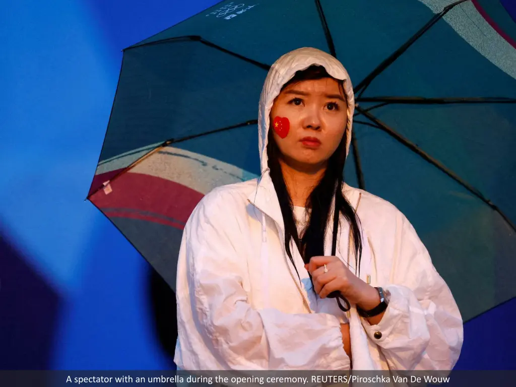 a spectator with an umbrella during the opening