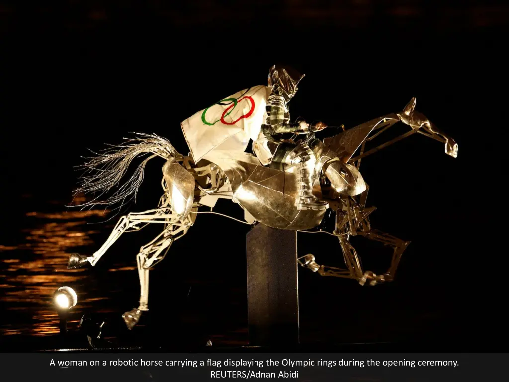 a woman on a robotic horse carrying a flag