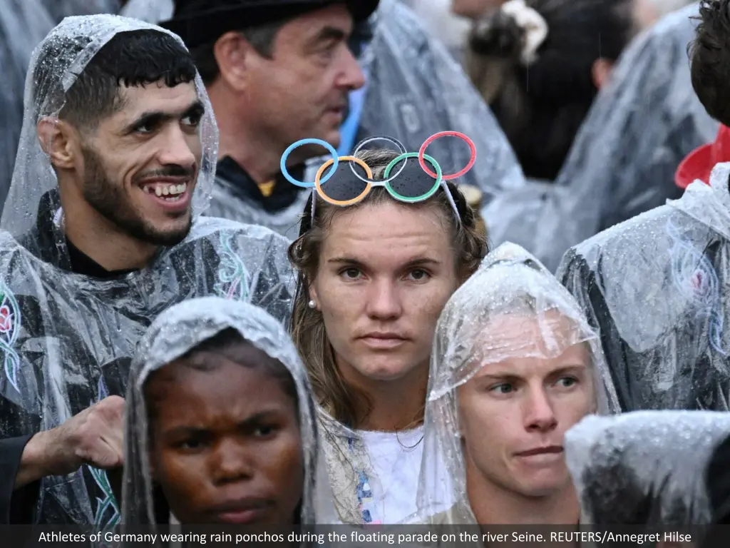 athletes of germany wearing rain ponchos during