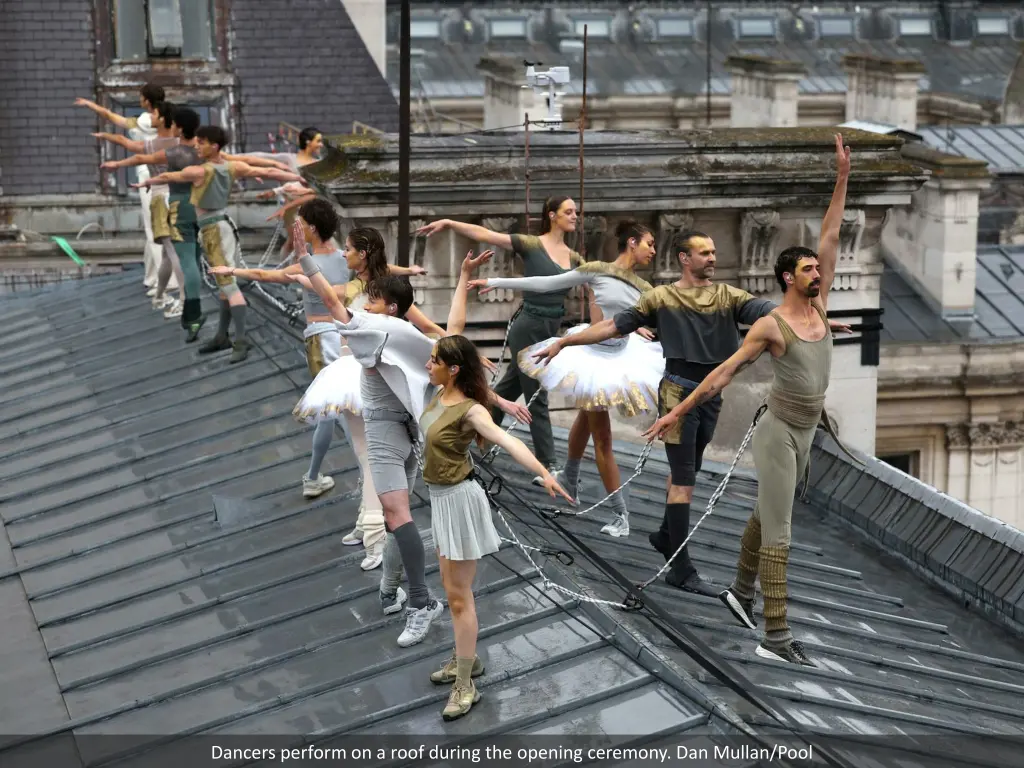 dancers perform on a roof during the opening