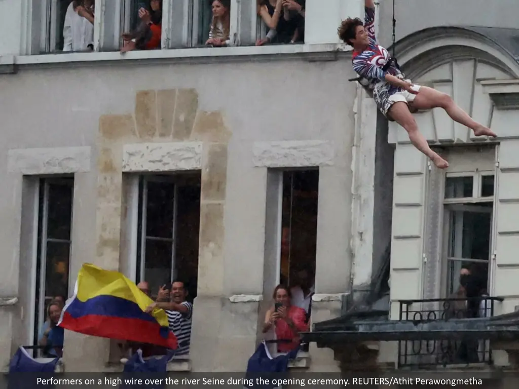 performers on a high wire over the river seine