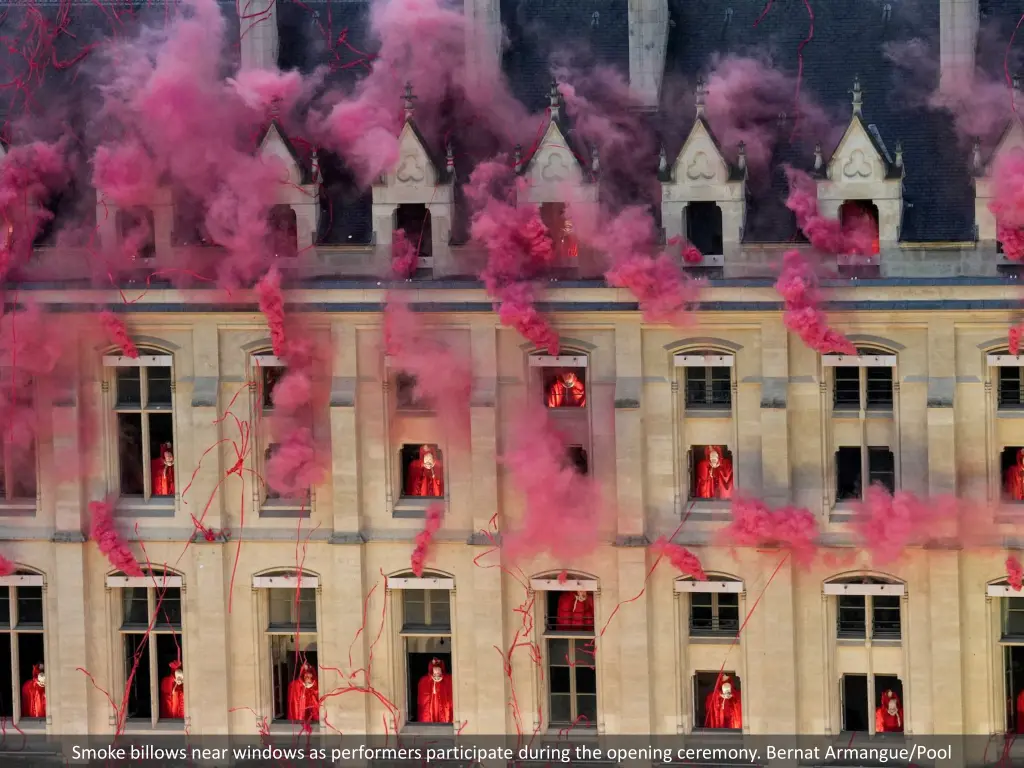 smoke billows near windows as performers