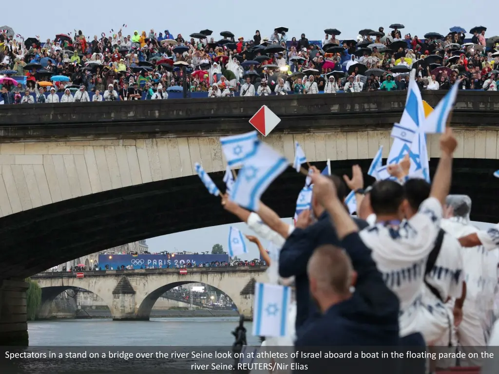 spectators in a stand on a bridge over the river