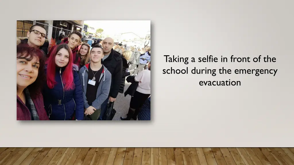 taking a selfie in front of the school during