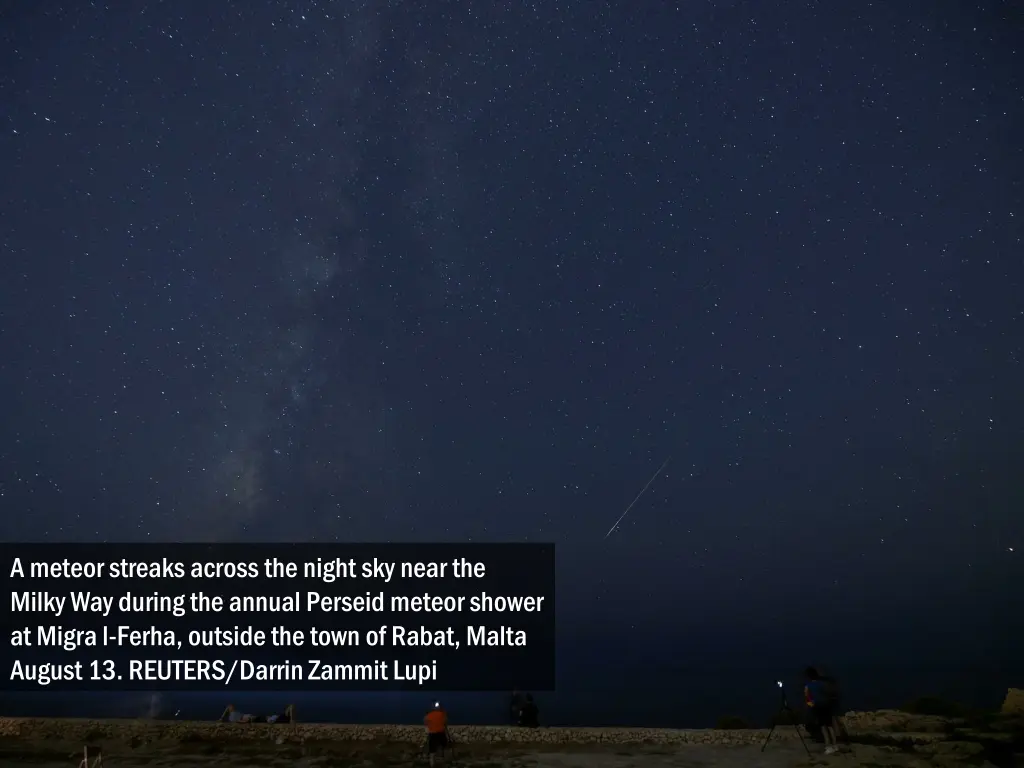 a meteor streaks across the night sky near 1