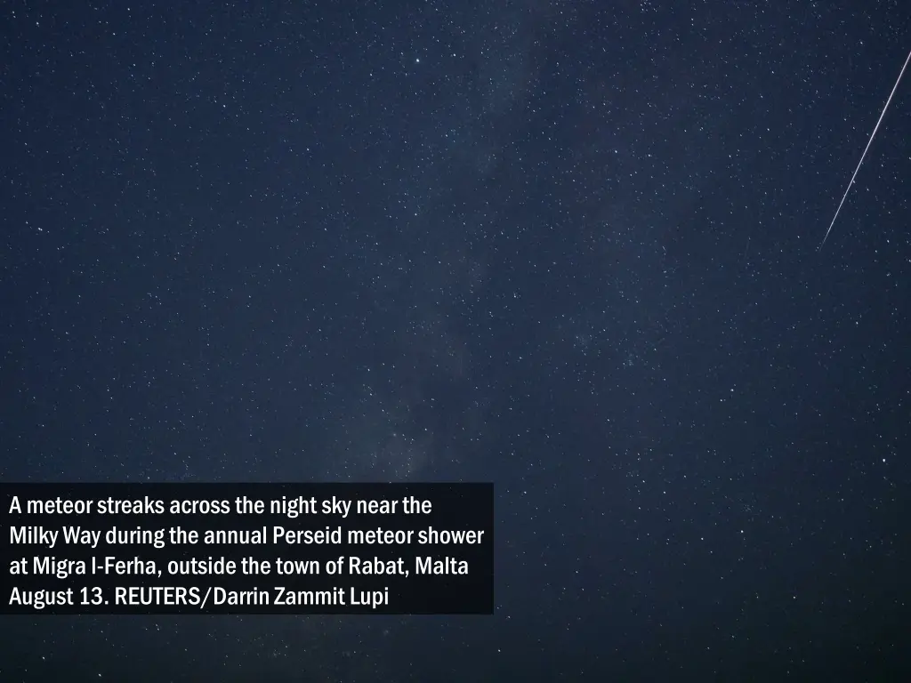 a meteor streaks across the night sky near