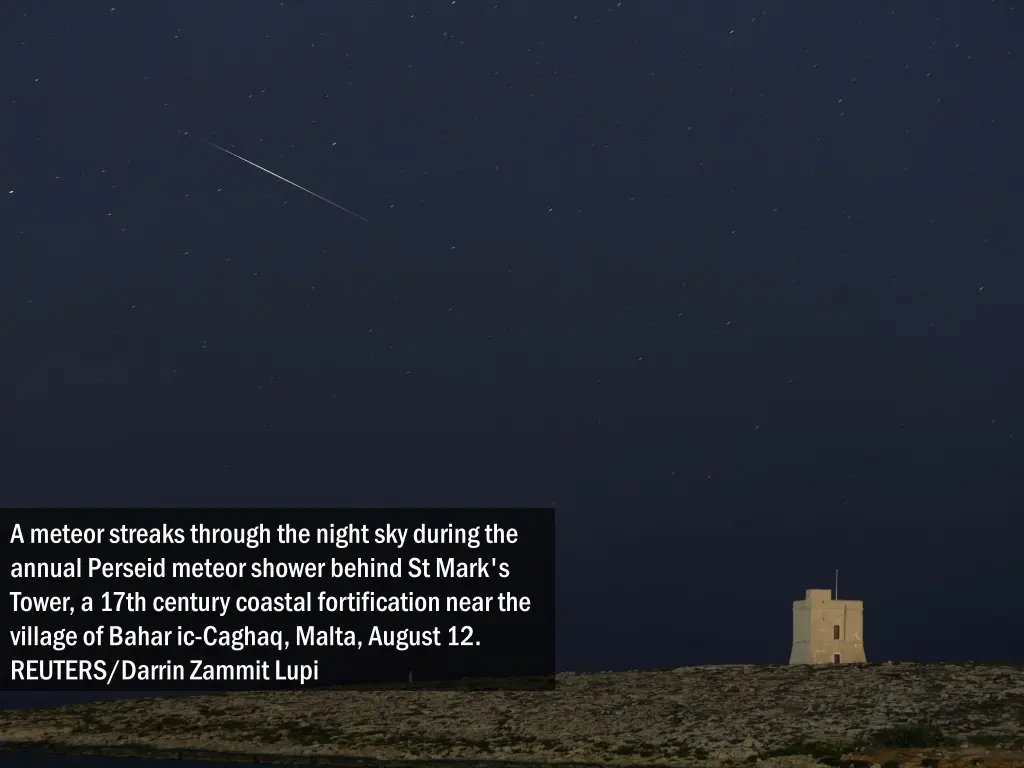 a meteor streaks through the night sky during