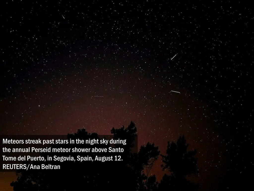 meteors streak past stars in the night sky during