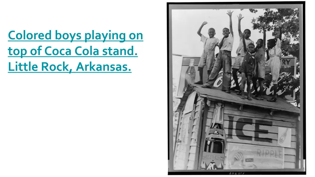 colored boys playing on top of coca cola stand