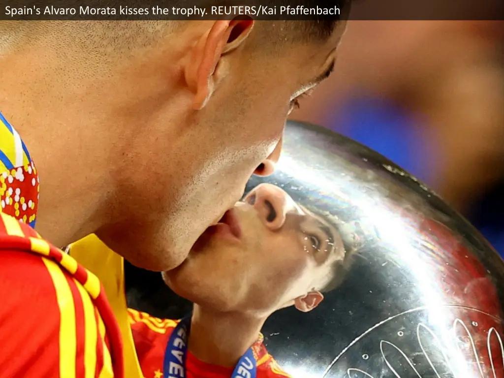 spain s alvaro morata kisses the trophy reuters