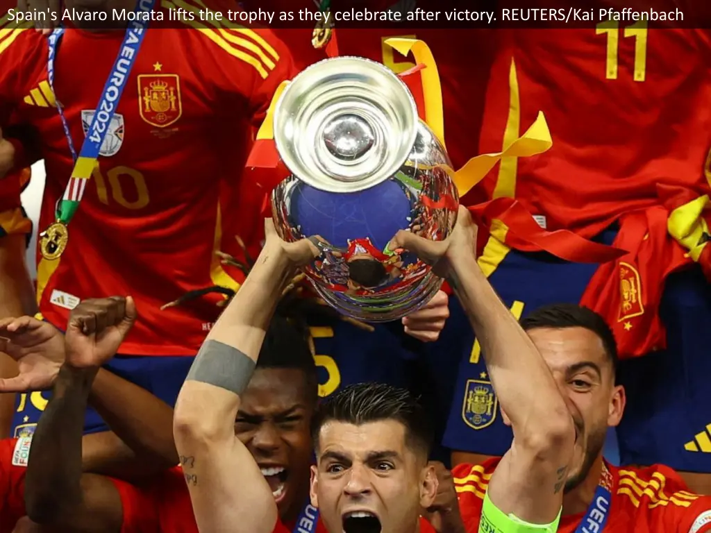 spain s alvaro morata lifts the trophy as they