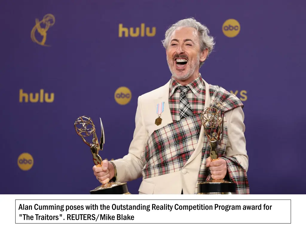 alan cumming poses with the outstanding reality