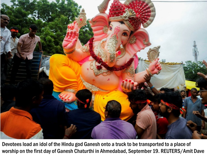 devotees load an idol of the hindu god ganesh