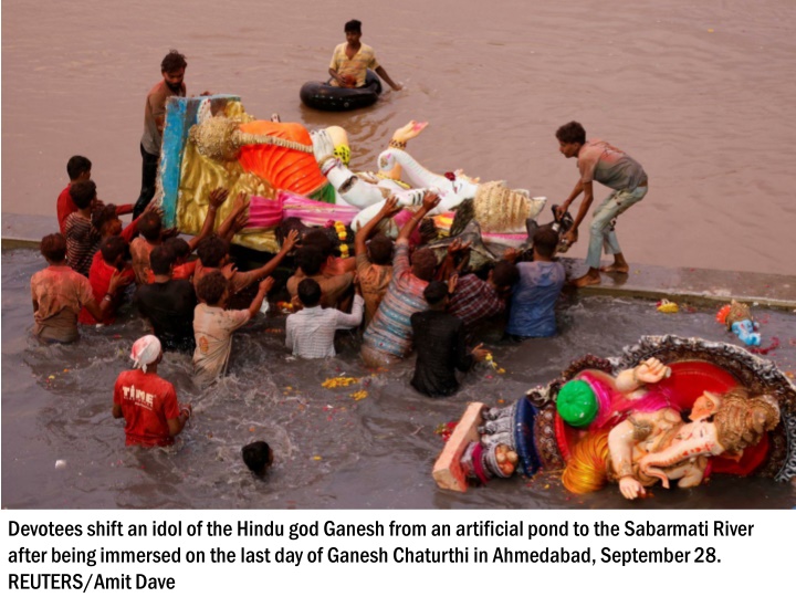 devotees shift an idol of the hindu god ganesh