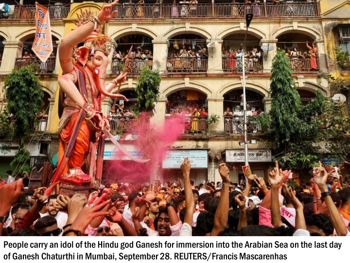 people carry an idol of the hindu god ganesh