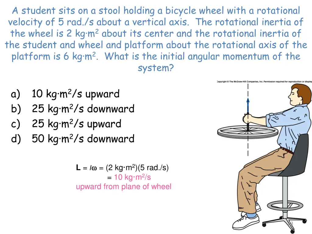 a student sits on a stool holding a bicycle wheel