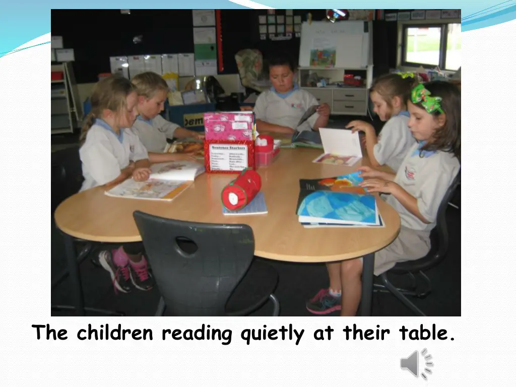 the children reading quietly at their table