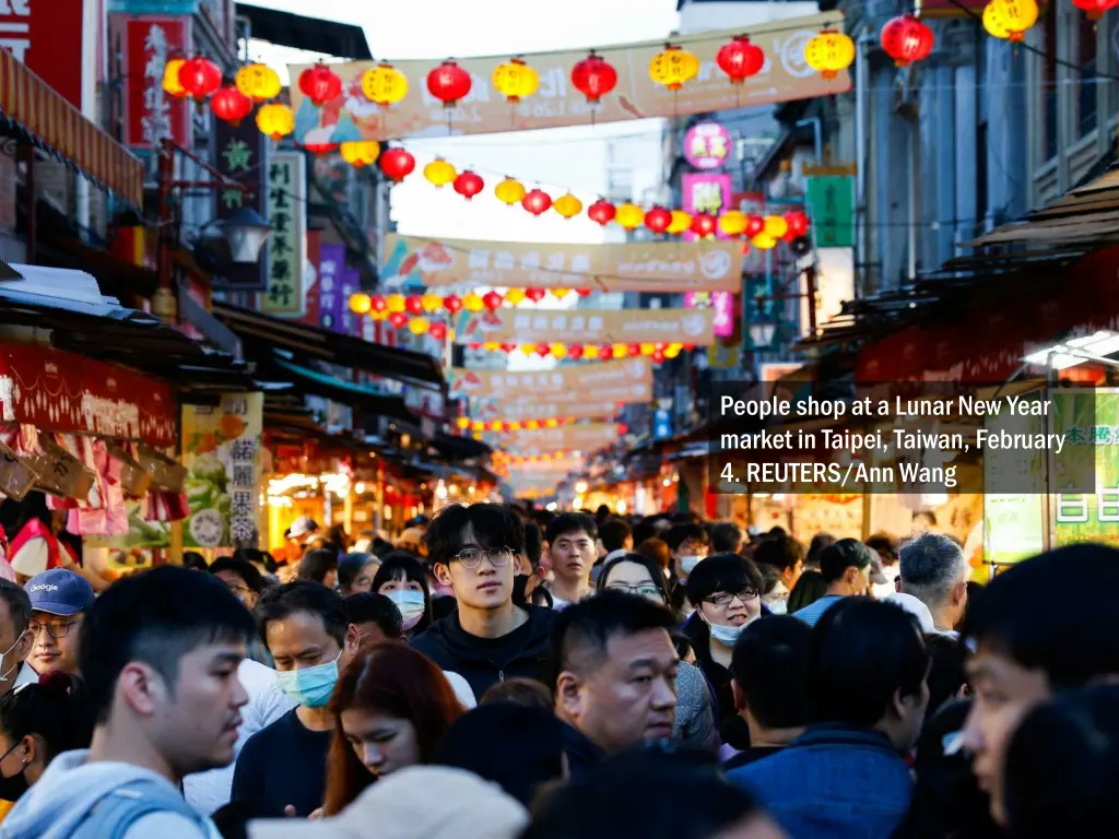 people shop at a lunar new year market in taipei