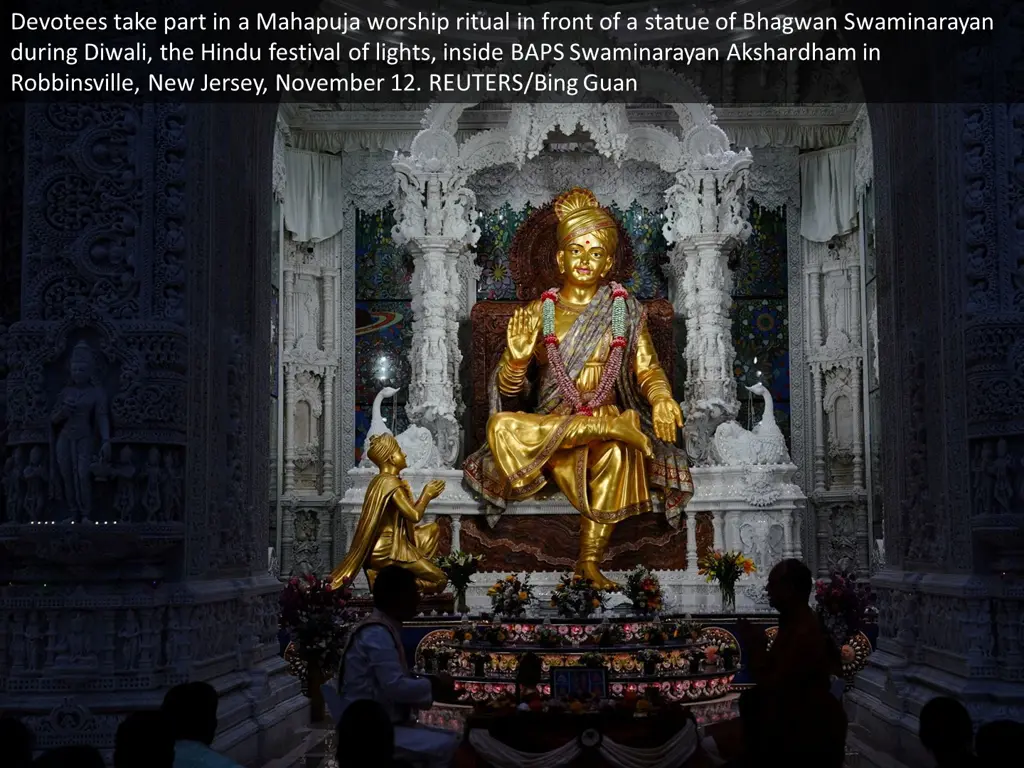 devotees take part in a mahapuja worship ritual