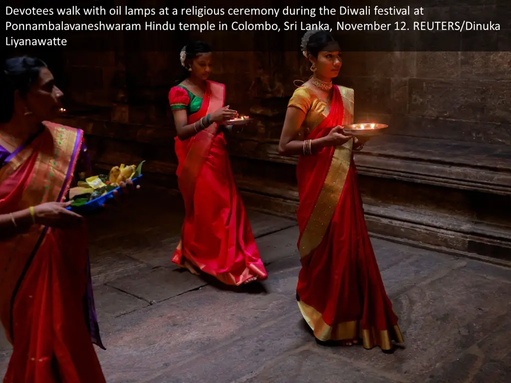 devotees walk with oil lamps at a religious