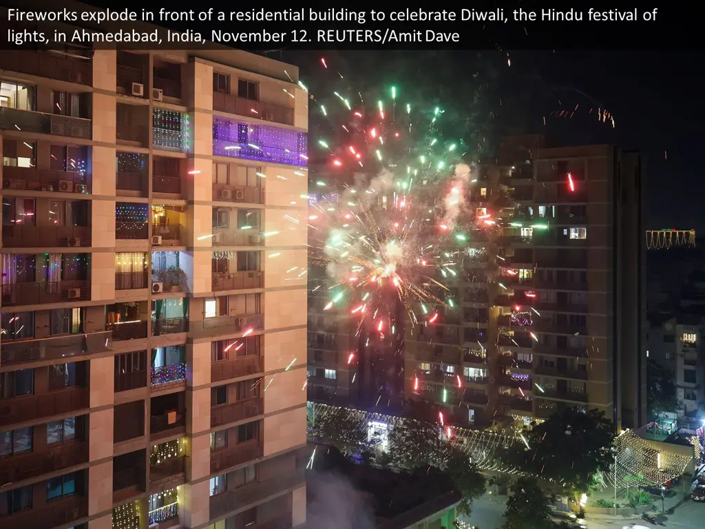 fireworks explode in front of a residential