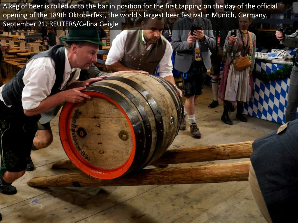 a keg of beer is rolled onto the bar in position