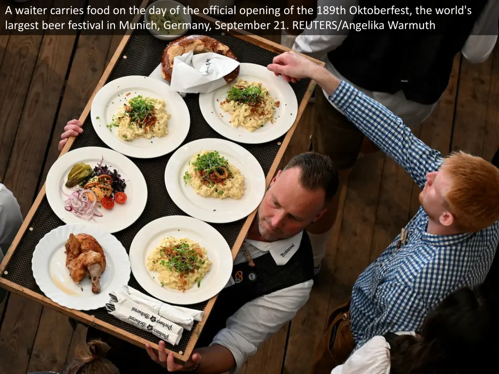 a waiter carries food on the day of the official