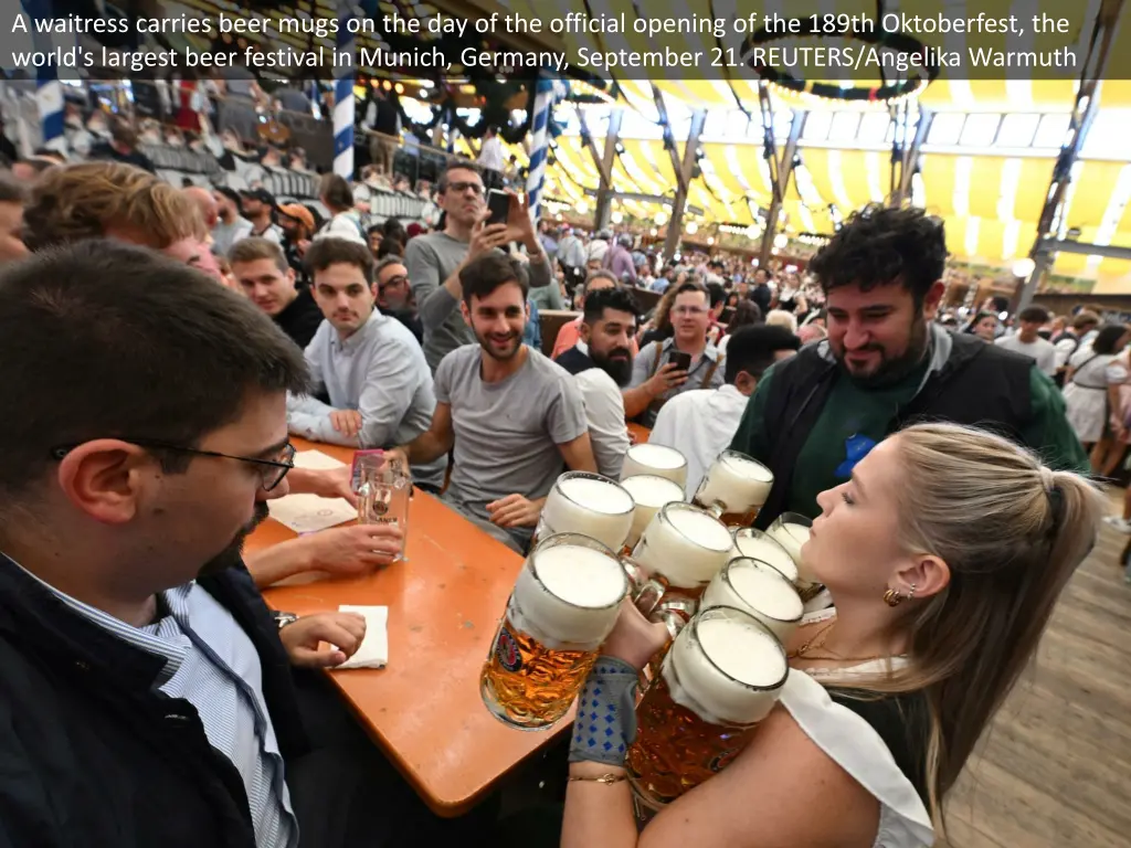 a waitress carries beer mugs 1