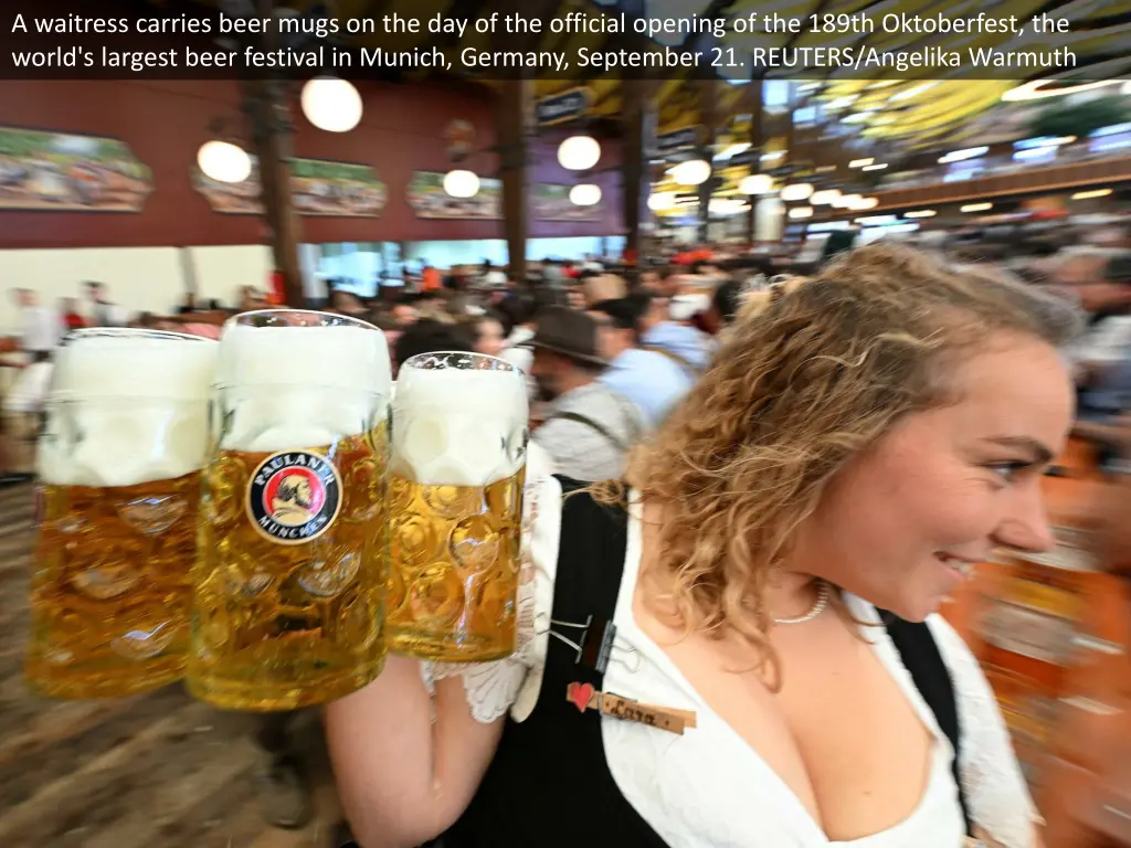 a waitress carries beer mugs