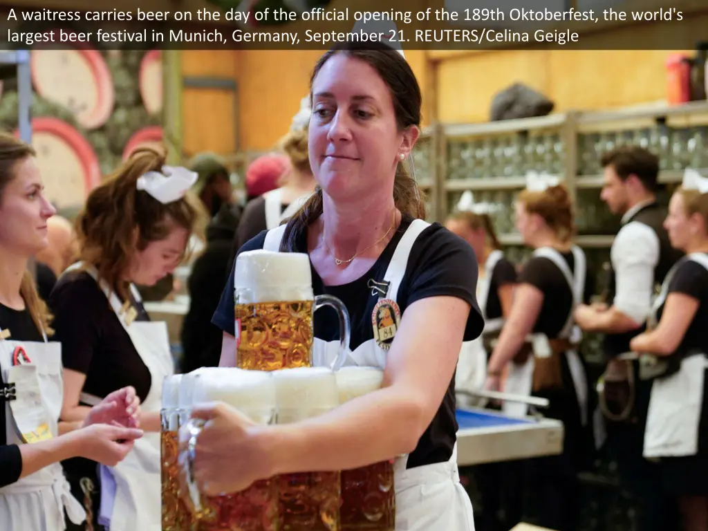 a waitress carries beer