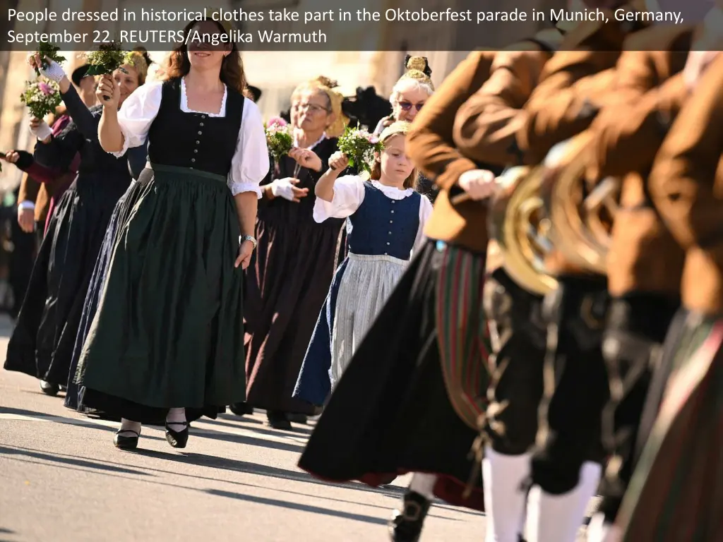 people dressed in historical clothes take part