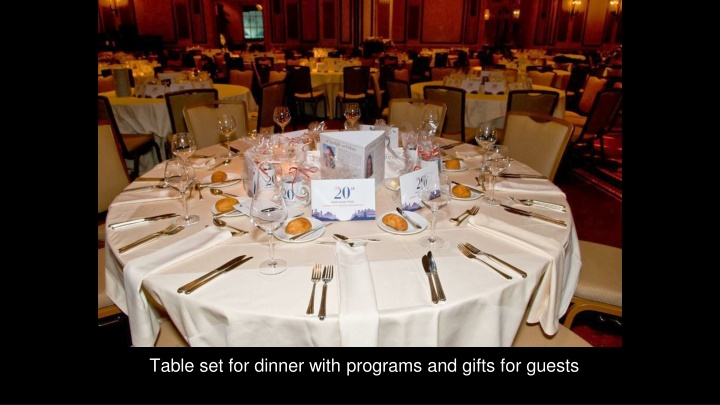 table set for dinner with programs and gifts