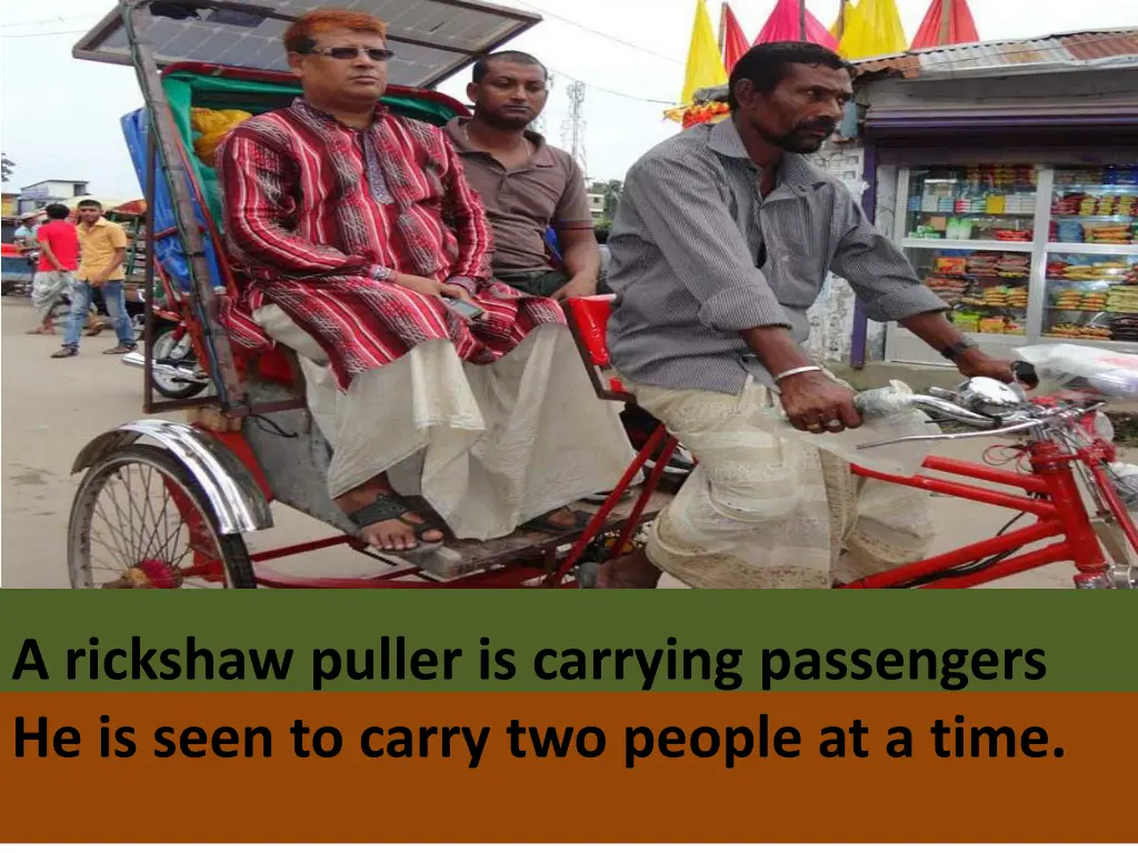 a rickshaw puller is carrying passengers