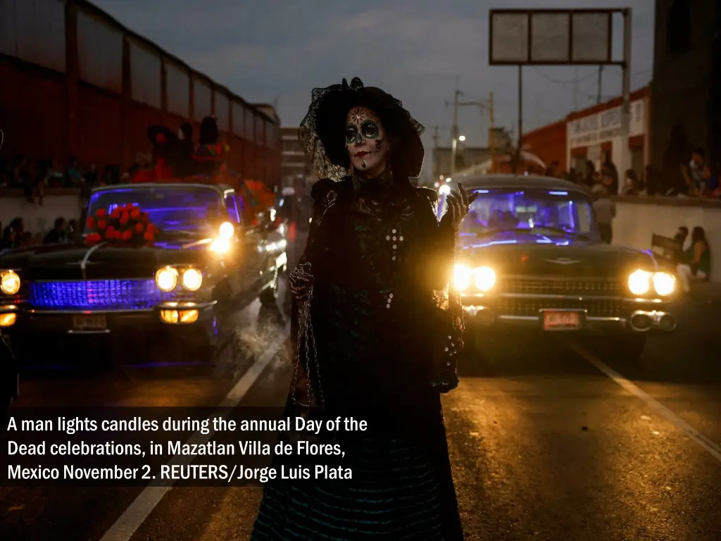 a man lights candles during the annual