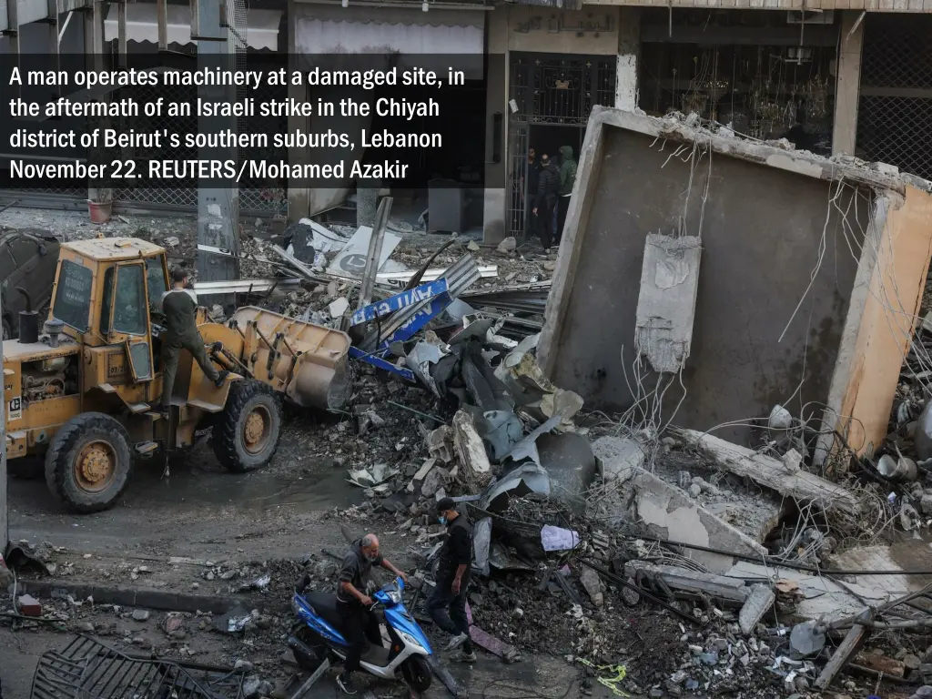 a man operates machinery at a damaged site