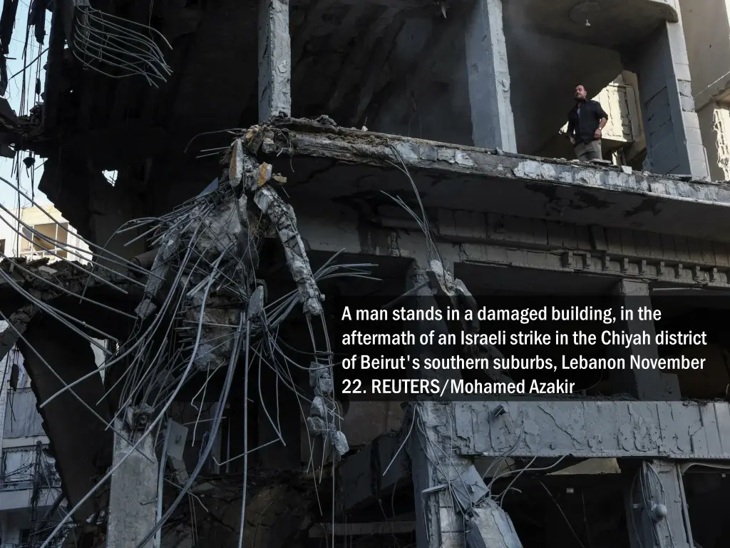 a man stands in a damaged building