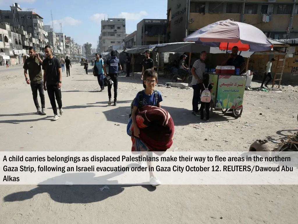 a child carries belongings as displaced