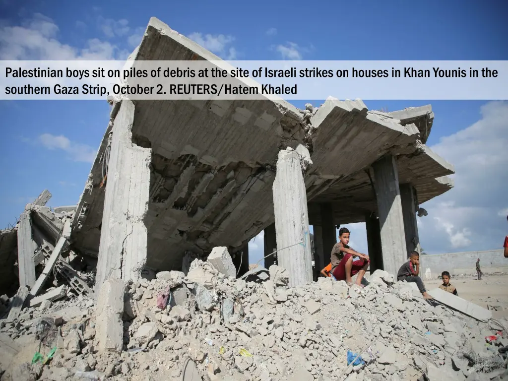 palestinian boys sit on piles of debris