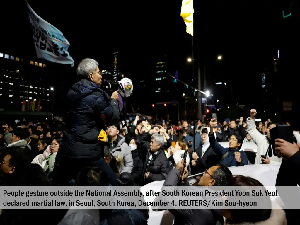 people gesture outside the national assembly