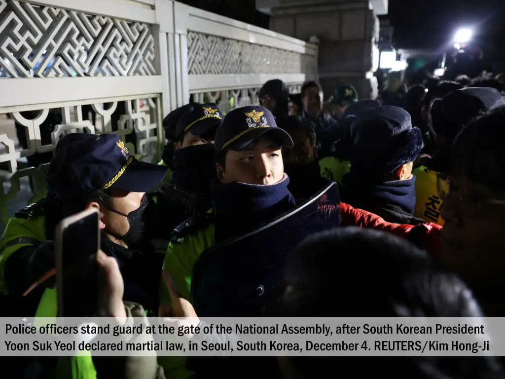 police officers stand guard at the gate