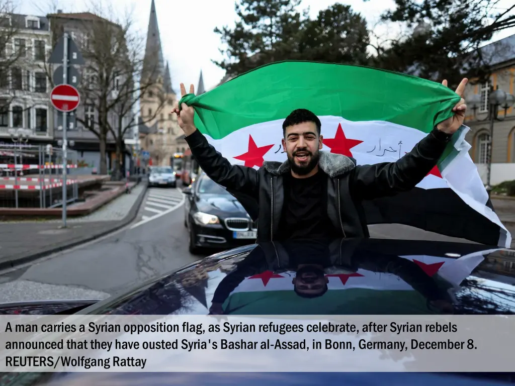 a man carries a syrian opposition flag as syrian