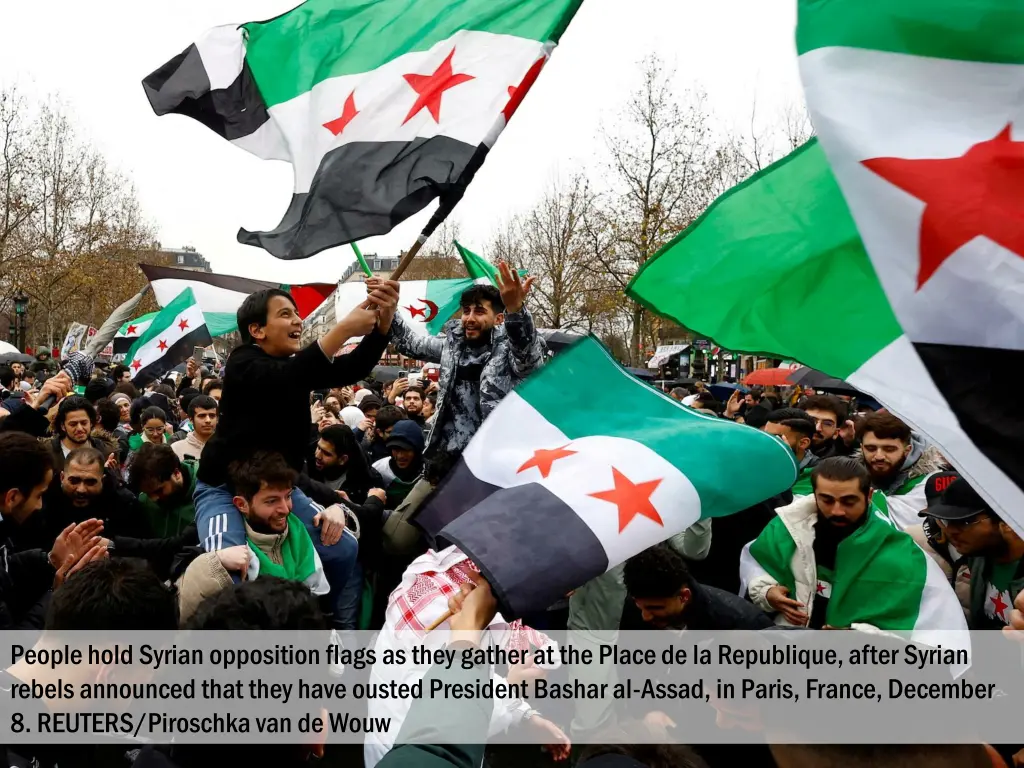 people hold syrian opposition flags as they 1