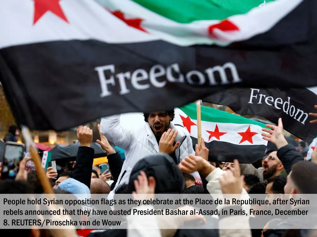 people hold syrian opposition flags as they 2