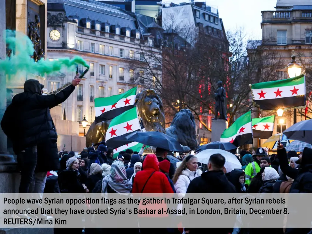 people wave syrian opposition flags as they