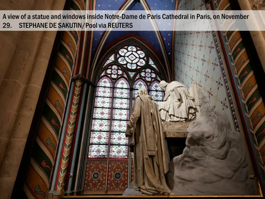 a view of a statue and windows inside notre dame