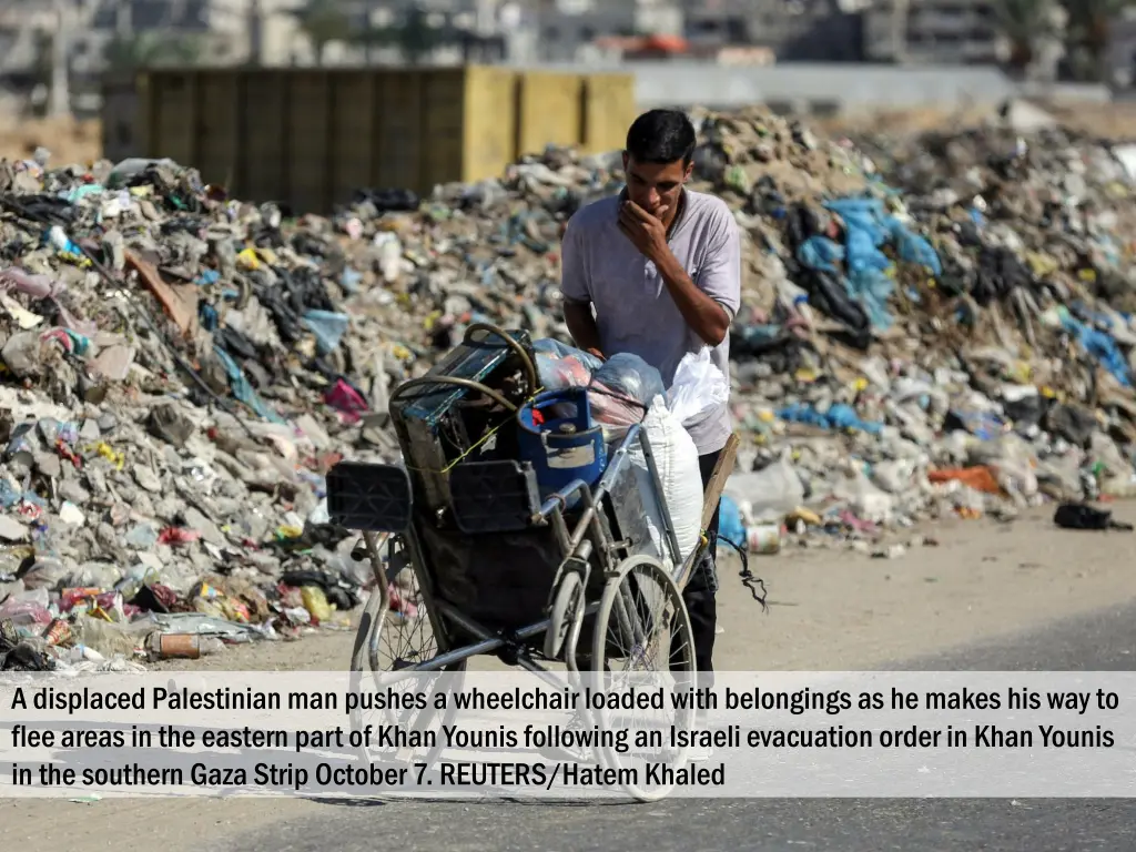 a displaced palestinian man pushes a wheelchair