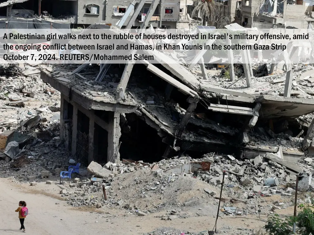 a palestinian girl walks next to the rubble