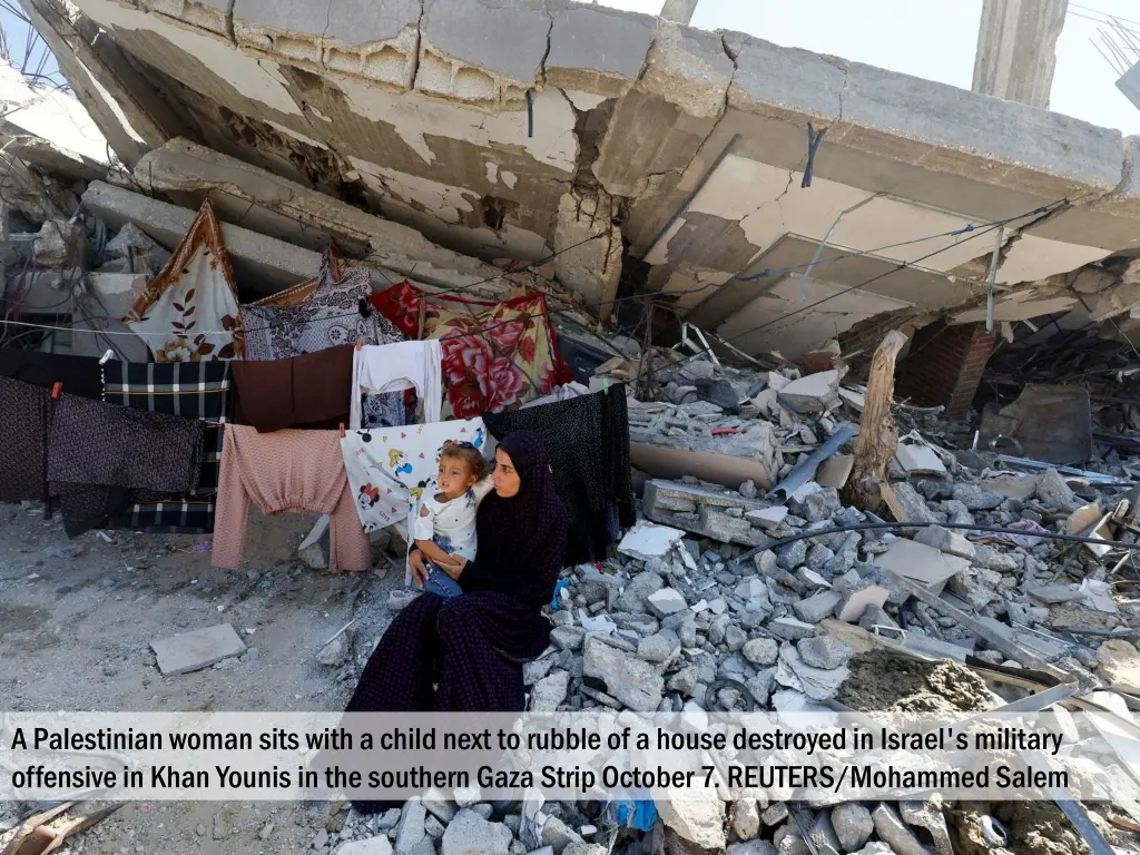 a palestinian woman sits with a child next